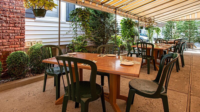 Outdoor dining area with set table for four
